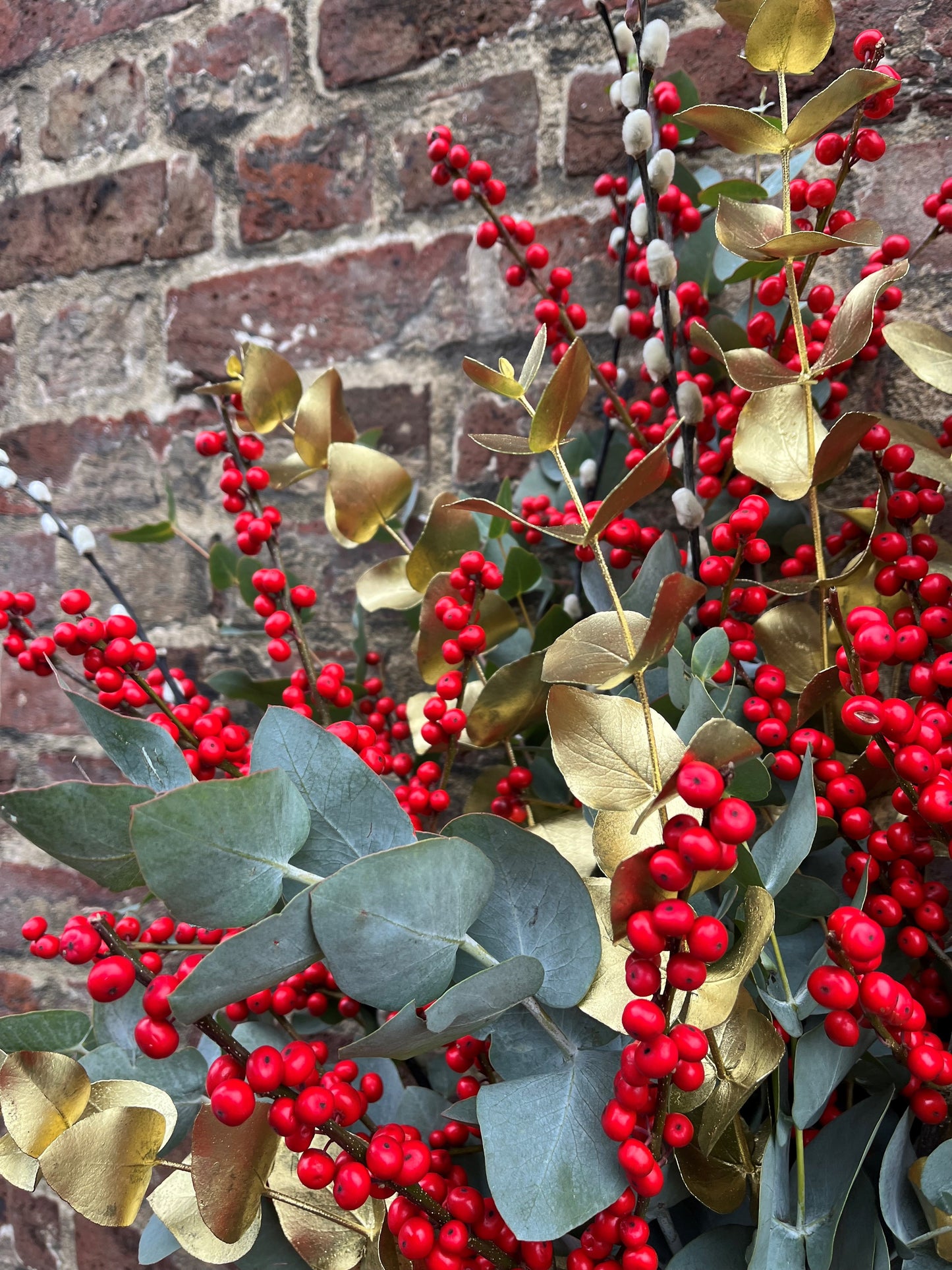Ilex berry, pussy willow, eucalyptus and gold arrangement