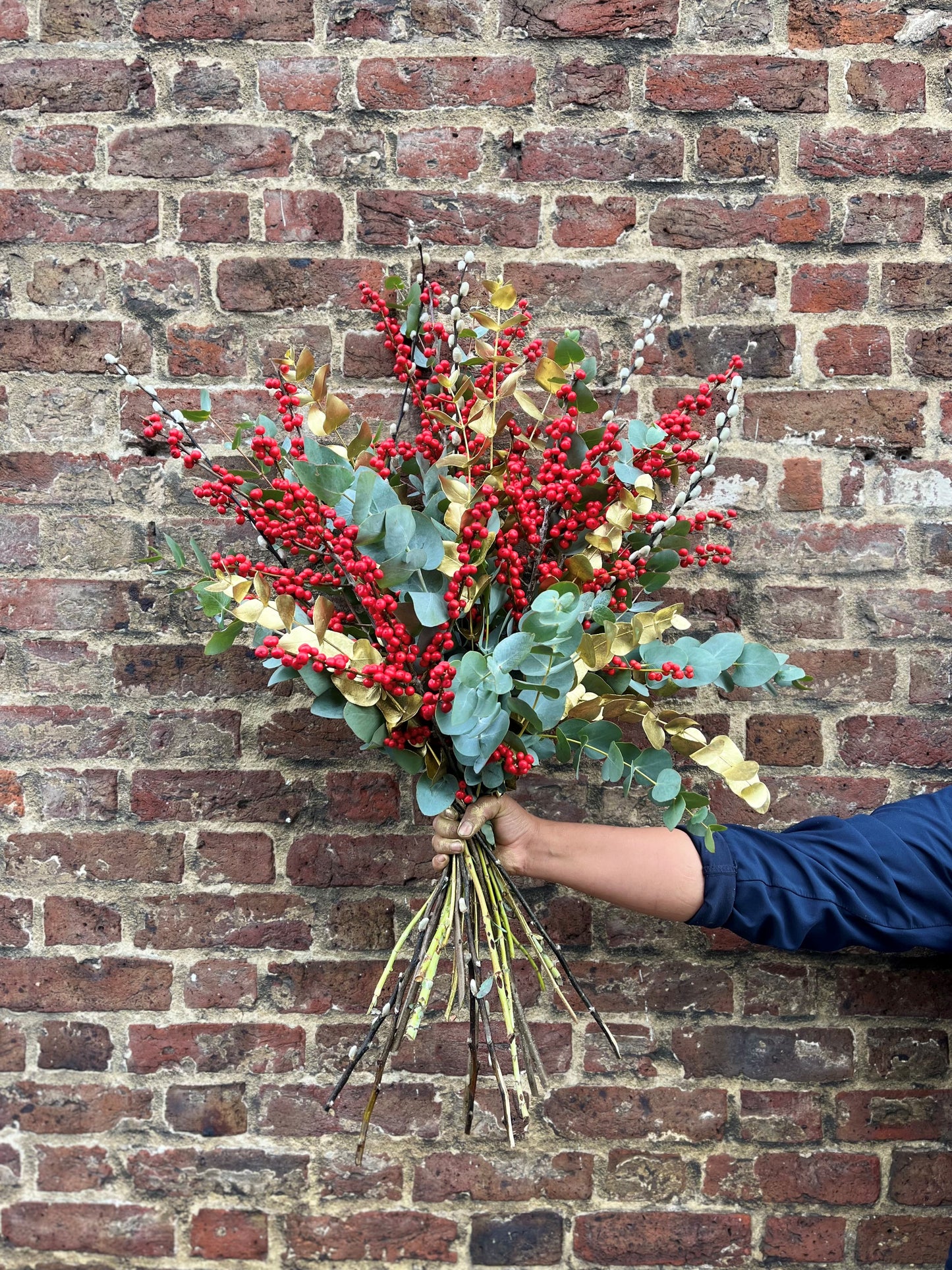 Ilex berry, pussy willow, eucalyptus and gold arrangement