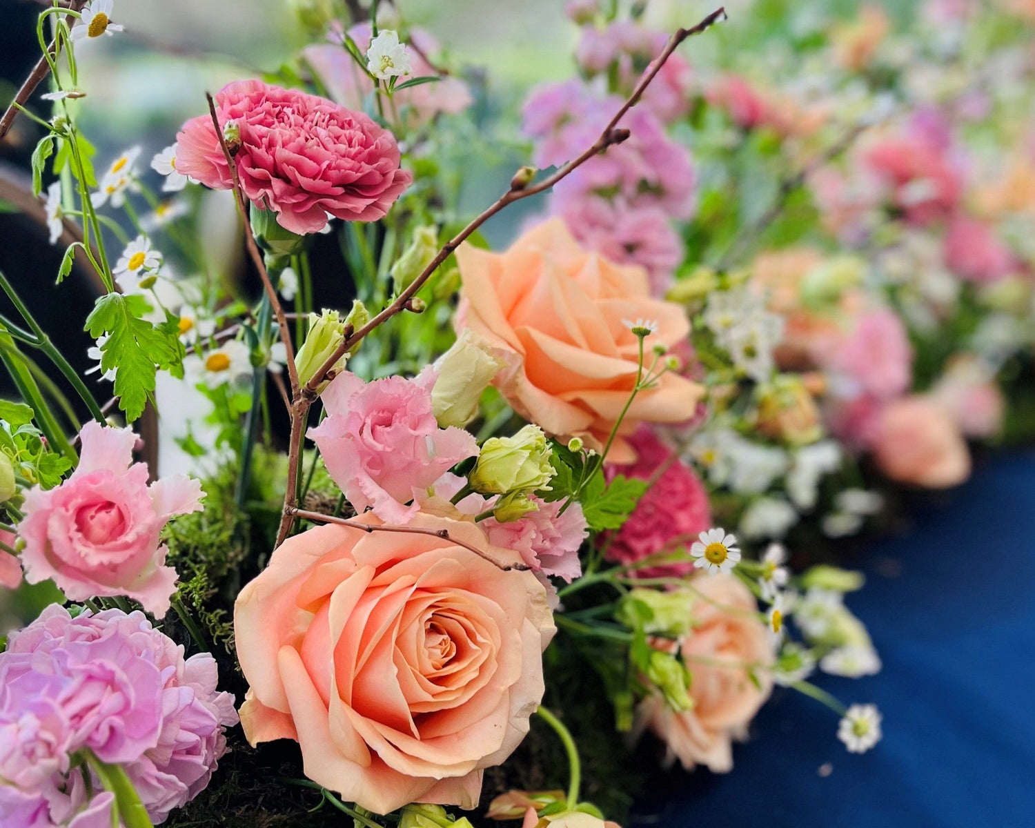 A bespoke sustainable spring table runner with seasonal flowers in pastel colours for a wedding by Gardenia of London