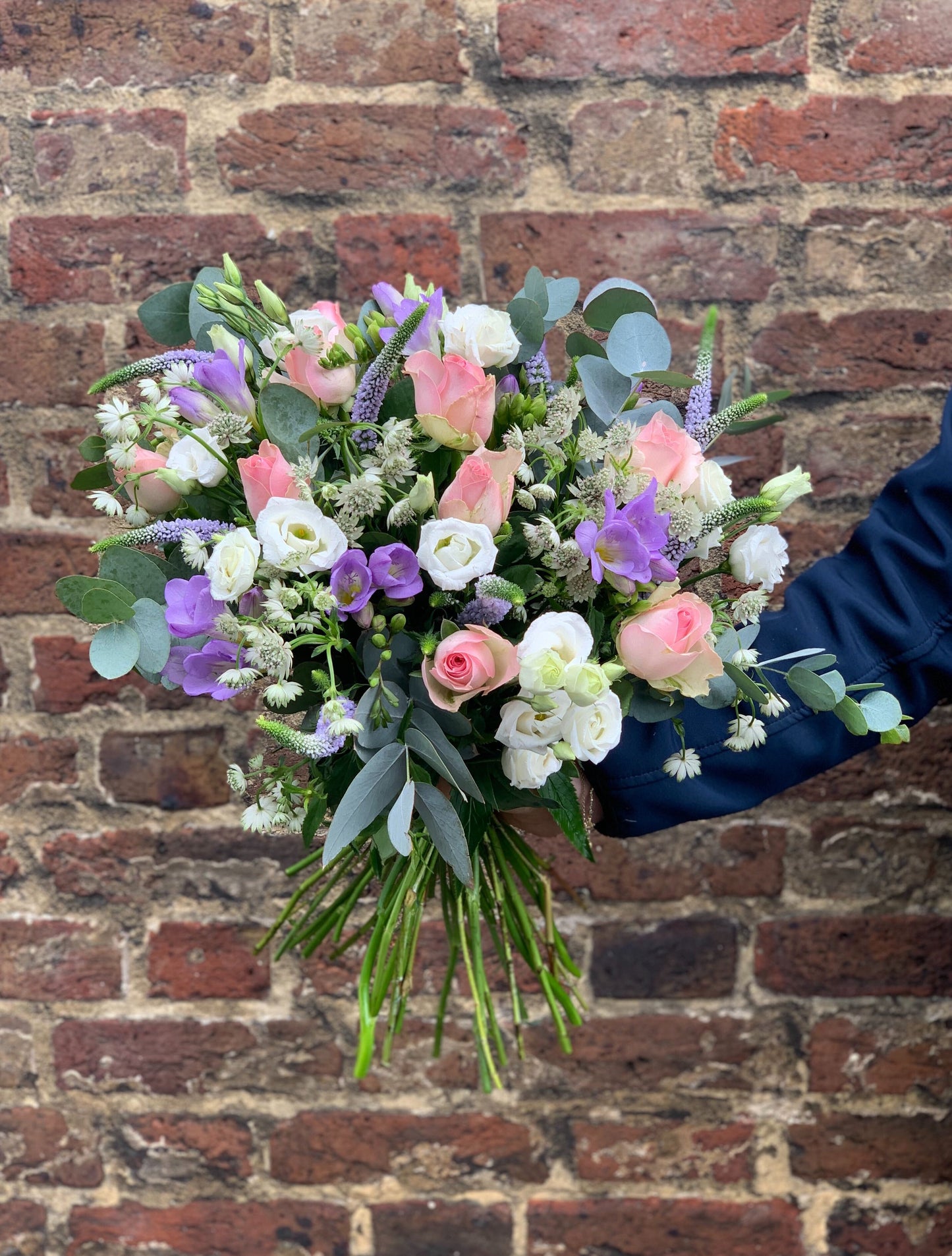 Seasonal Pretty Pastels Hand-Tied Bouquet featuring fresh, seasonal flowers in soft pastel hues.
