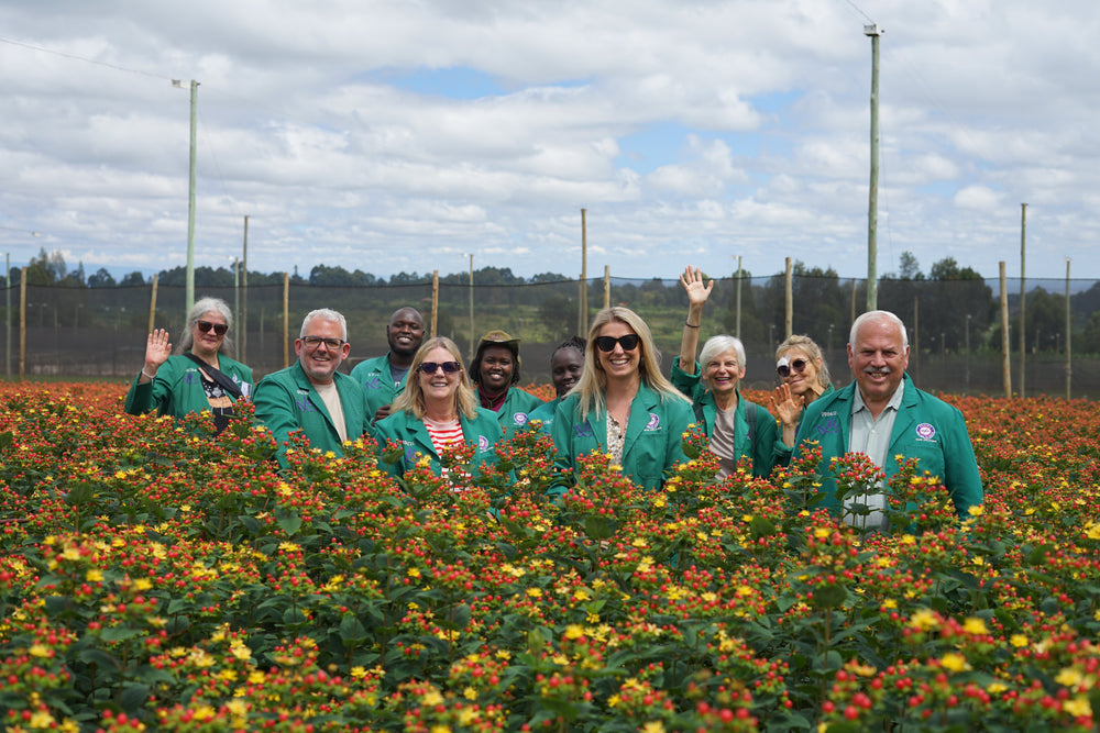 Jamie Grant and fellow visitors among flowers at a Marginpar farm in Kenya