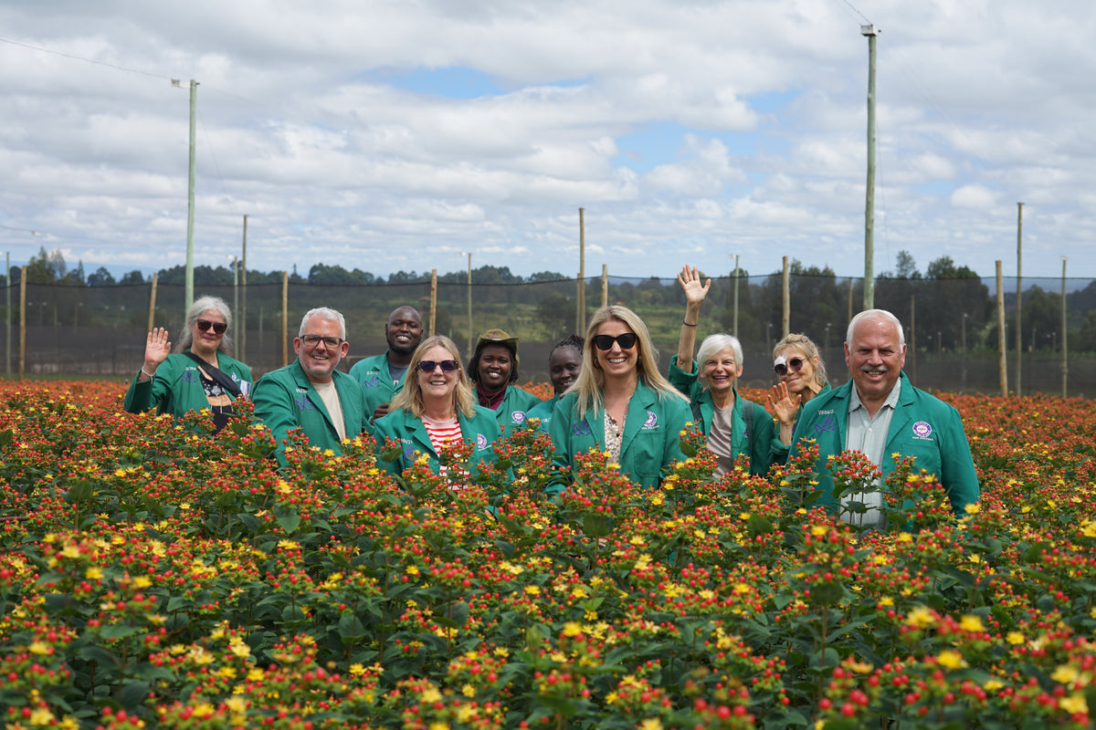 Jamie Grant and fellow visitors among flowers at a Marginpar farm in Kenya
