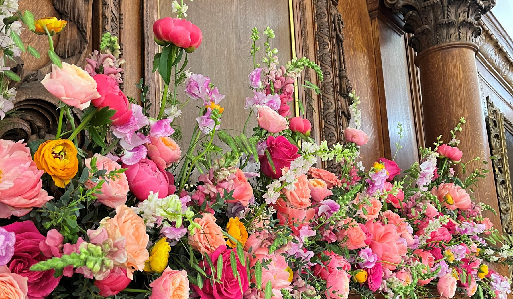 Colourful wedding mantel flowers designed by Gardenia of London