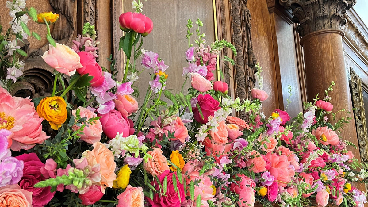 Colourful wedding mantel flowers by Gardenia of London