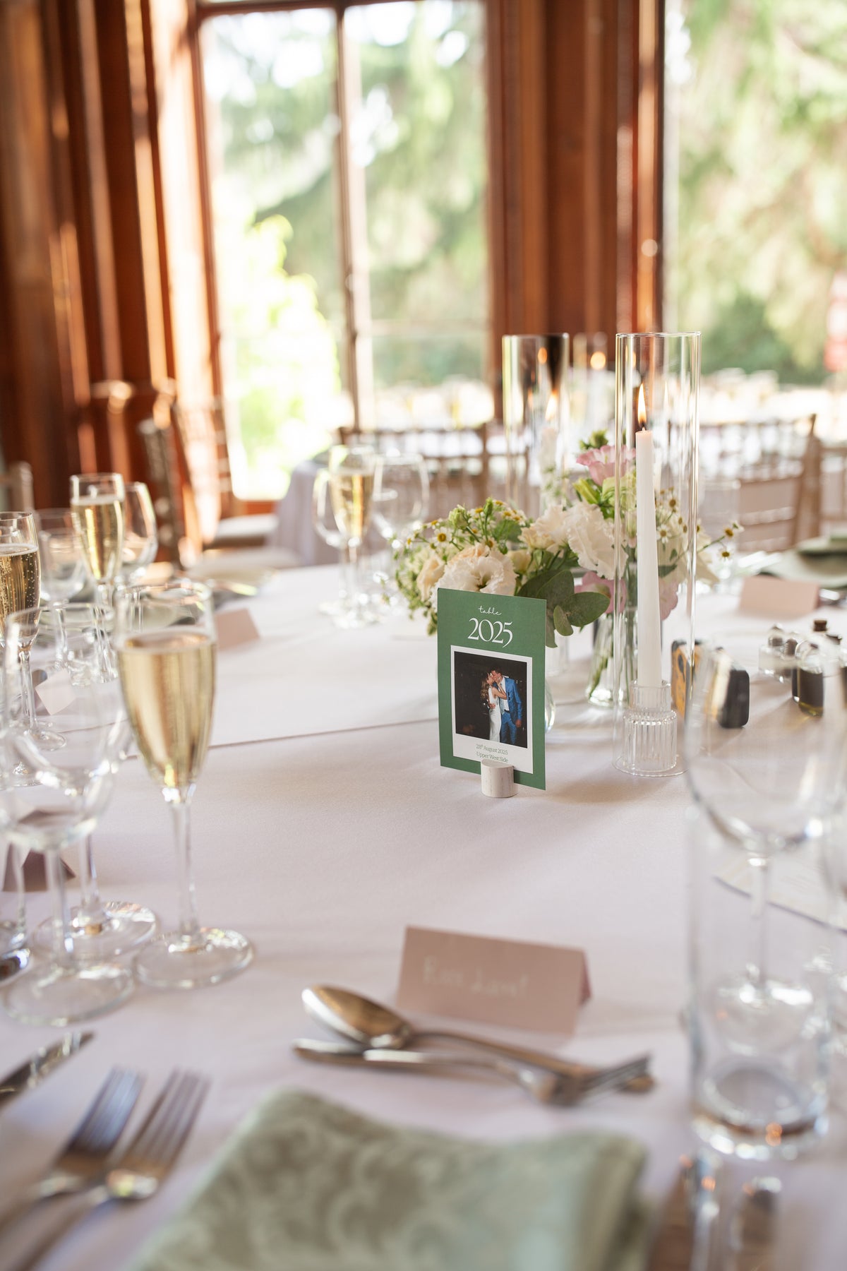 Bright tumbling mantel flowers decorating a wedding venue by Gardenia of London