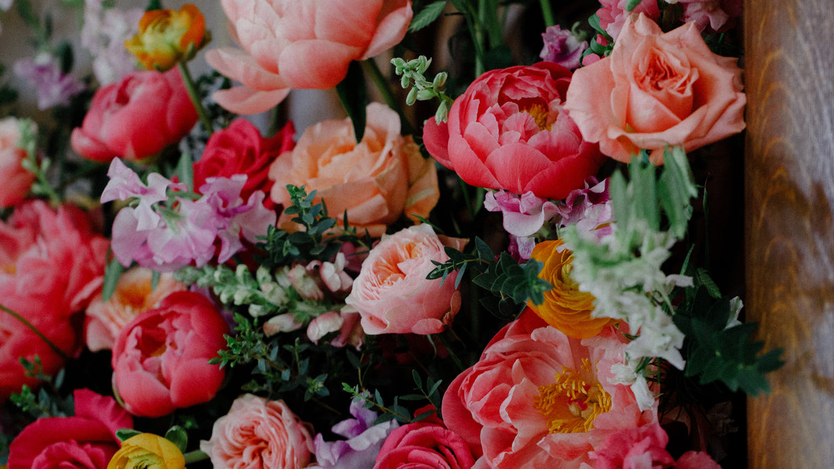 Luxury bespoke wedding flower installation in coral, pink and peach by Gardenia of London