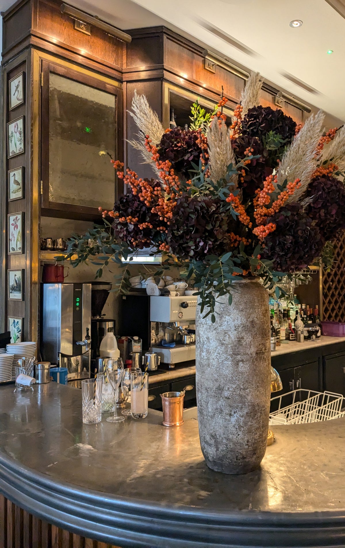 Real autumn reception vase made by Gardenia using dark hydrangeas, orange berries and fine natural grasses