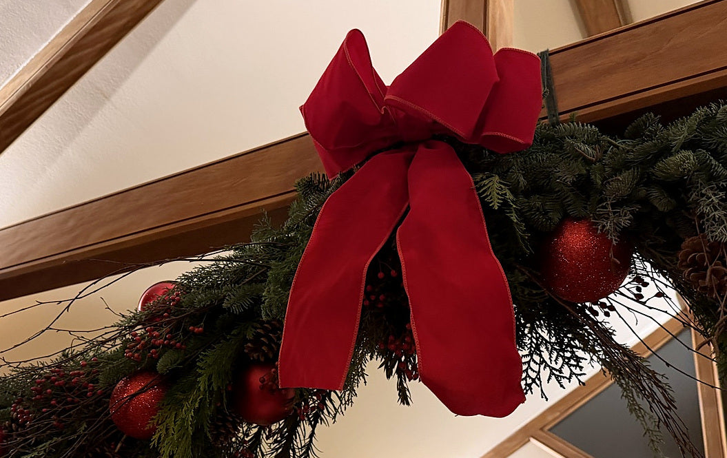 Genuine Gardenia handmade Christmas garland with red bow in a tightly cropped photograph