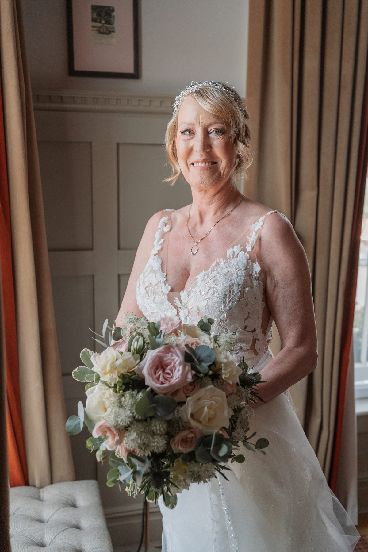Bride holding a blush, ivory and eucalyptus wedding bouquet by Gardenia of London