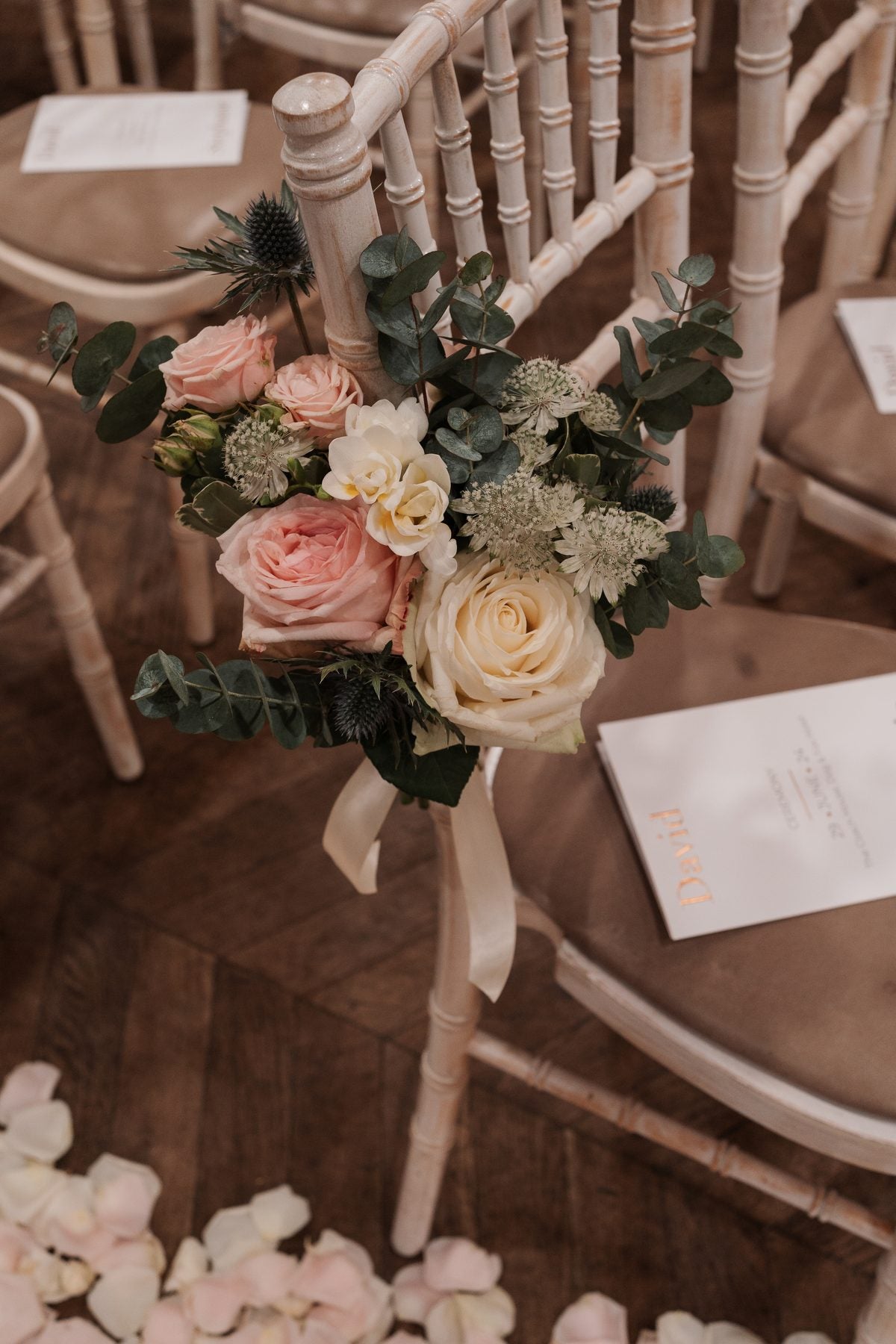 Blush and ivory ceremony flowers tied to a wedding chair by Gardenia of London
