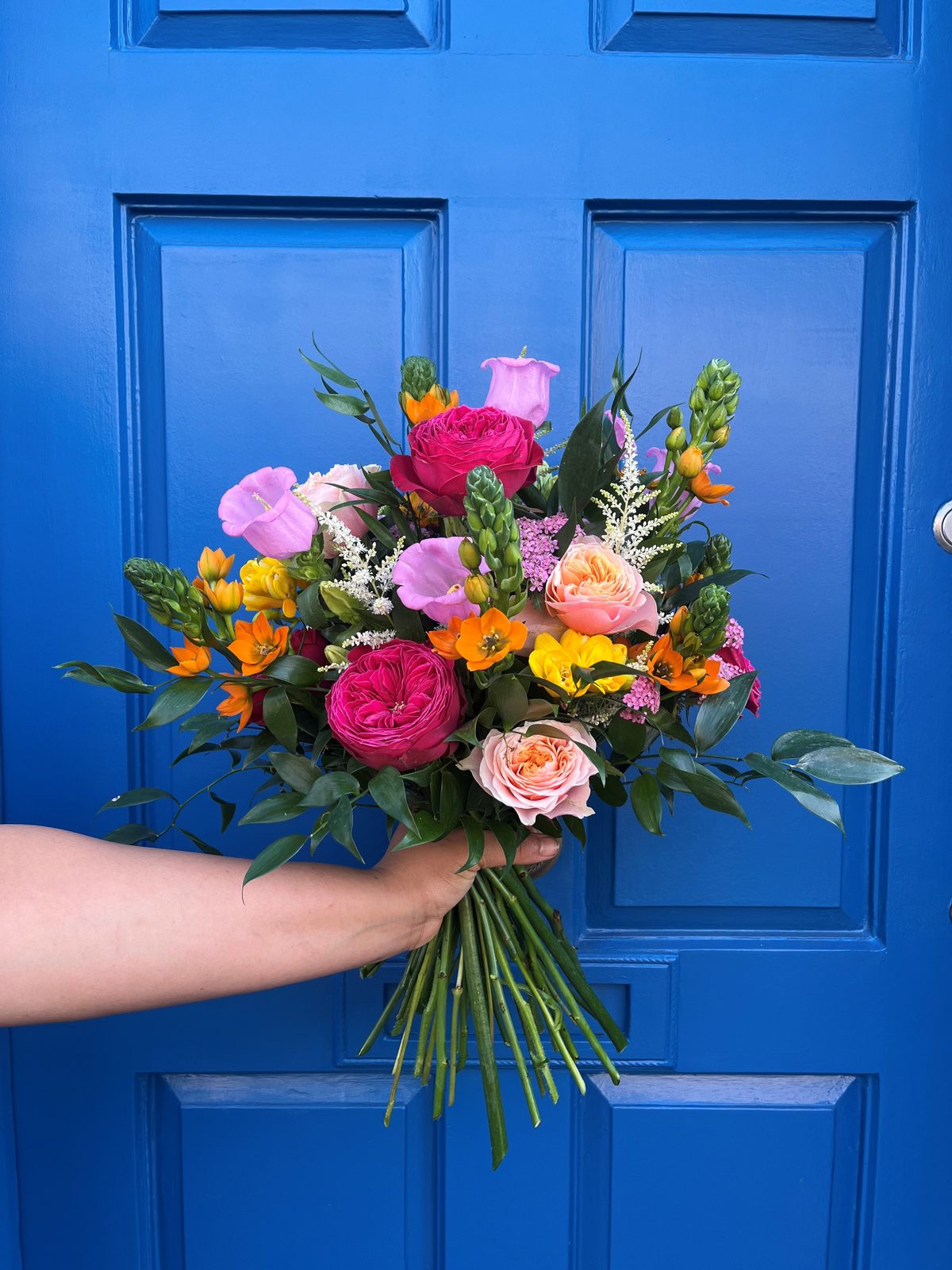 Colourful seasonal bridal bouquet by Gardenia of London