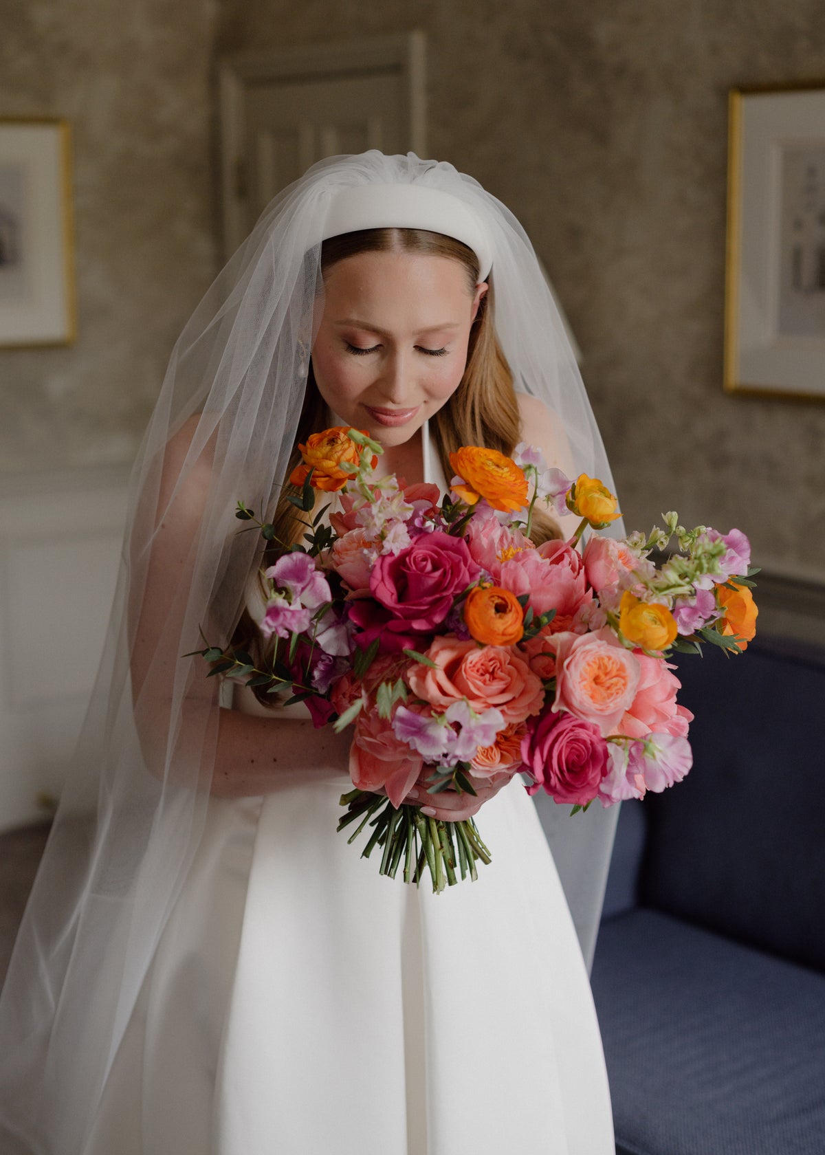 Bride holding a modern colourful Gardenia wedding bouquet